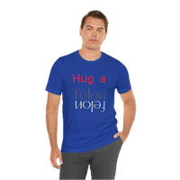 a man wearing a blue t - shirt that says a hug a year