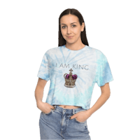 a woman wearing a blue tie dye crop top that says i am king